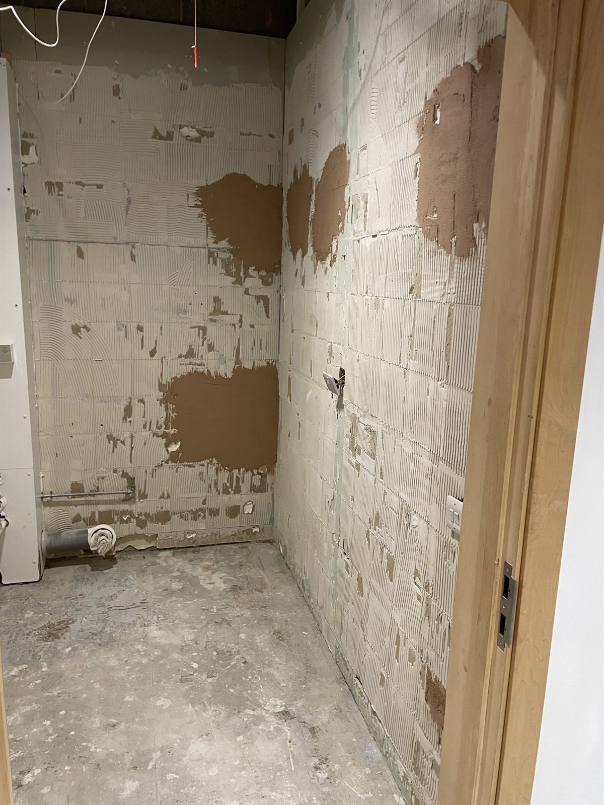 Washroom stripped back to blockwork during refurbishment