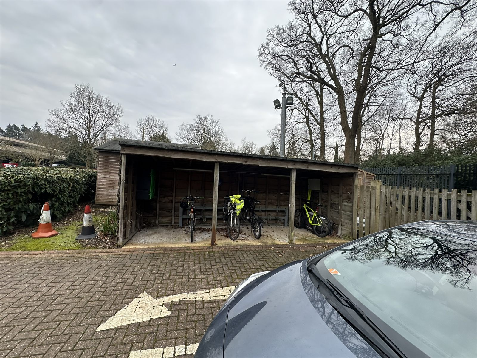 Original weathered cycle shelter before the works