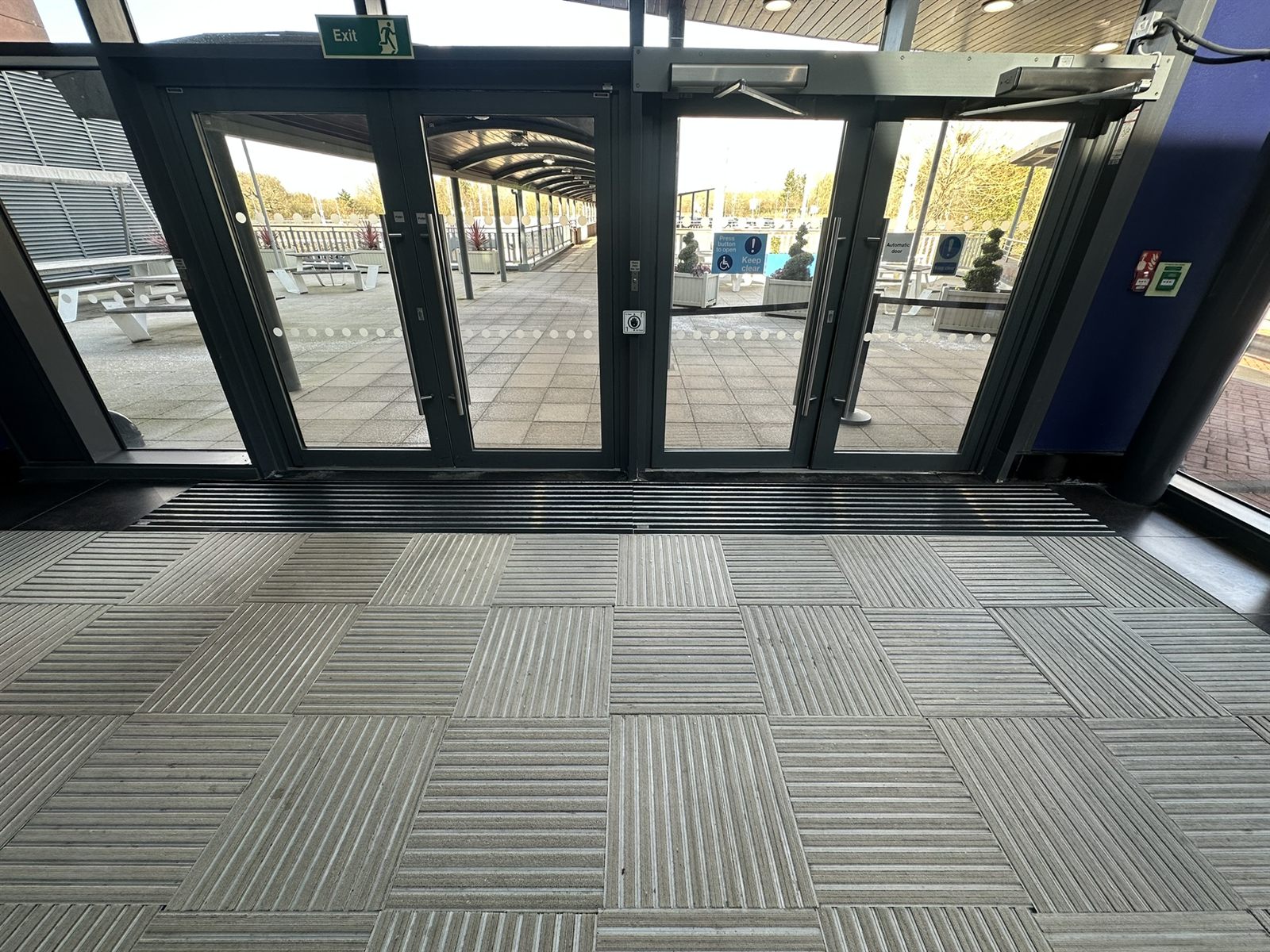 Long run of recessed barrier matting at a second site entrance