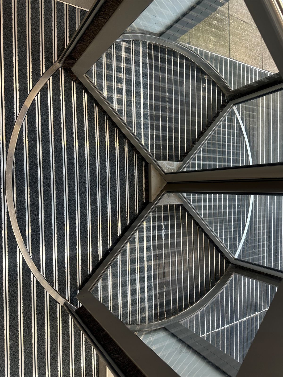 Finished recessed barrier matting viewed from above at a revolving-door entrance