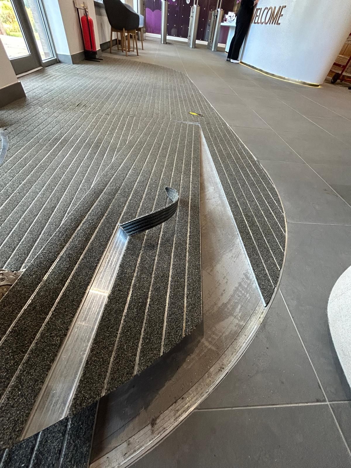 New barrier matting being cut and fitted into the entrance recess