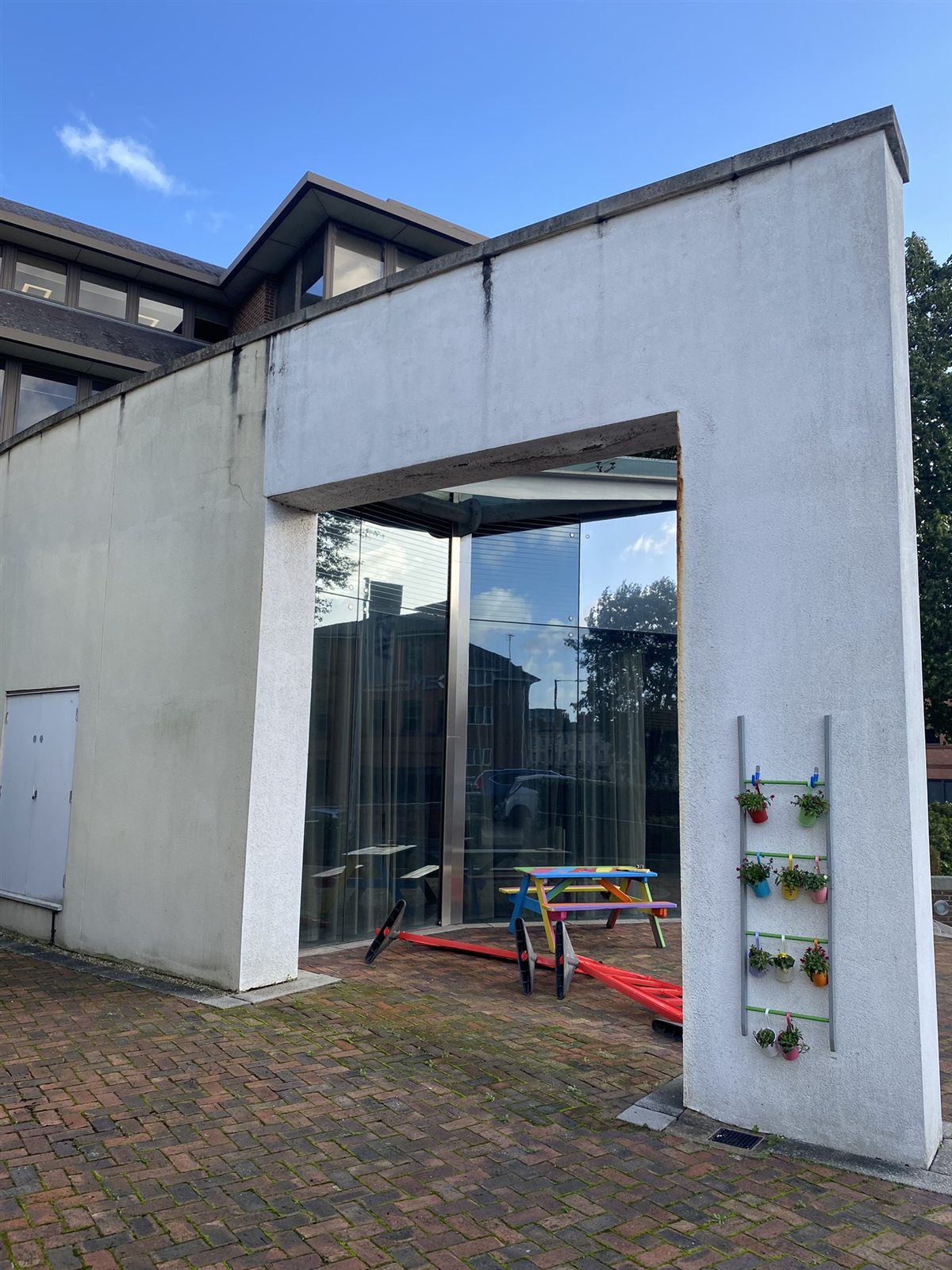 Weathered, stained render before the works