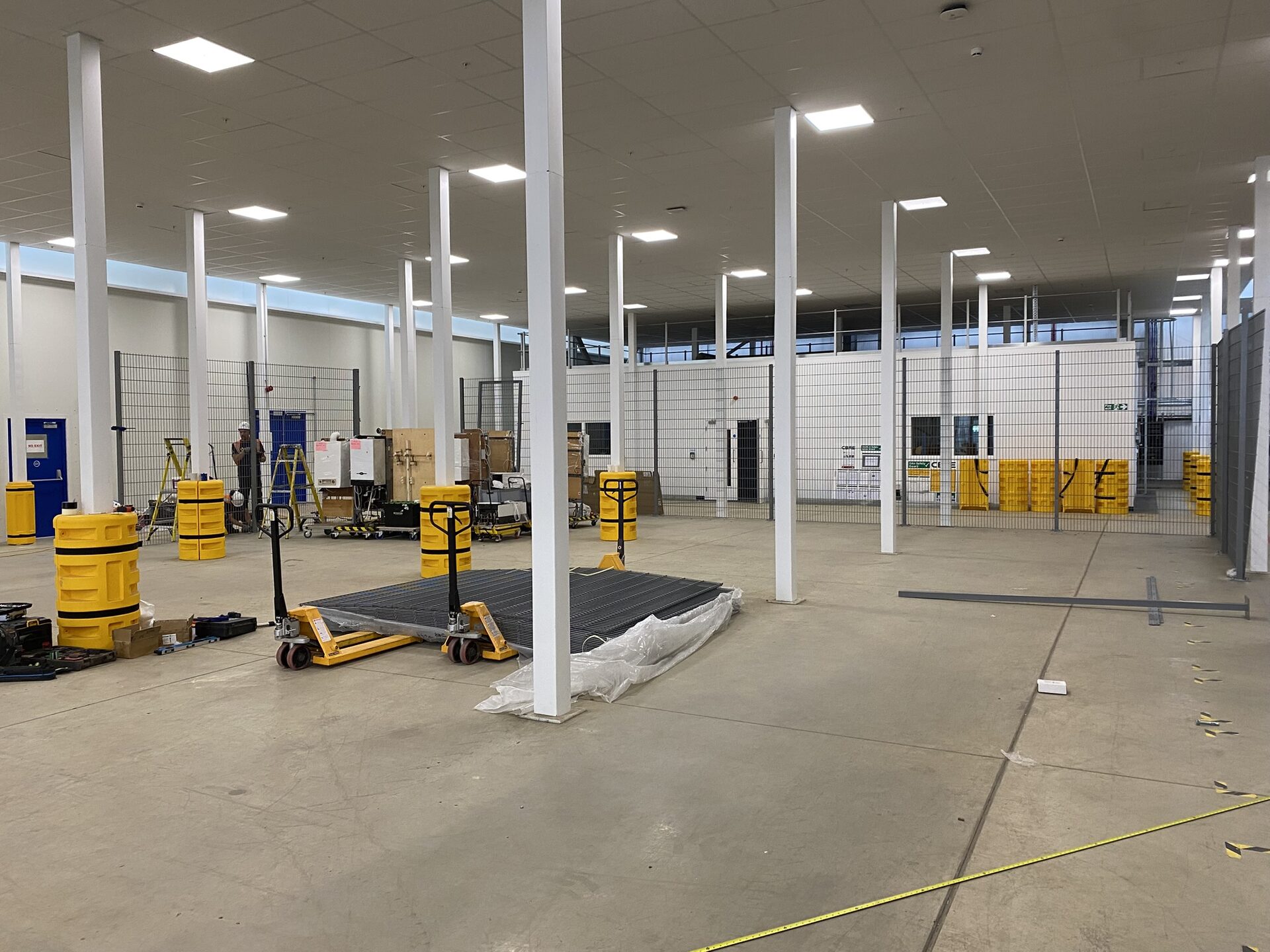 Warehouse fit-out in progress, mesh fencing panels ready for installation