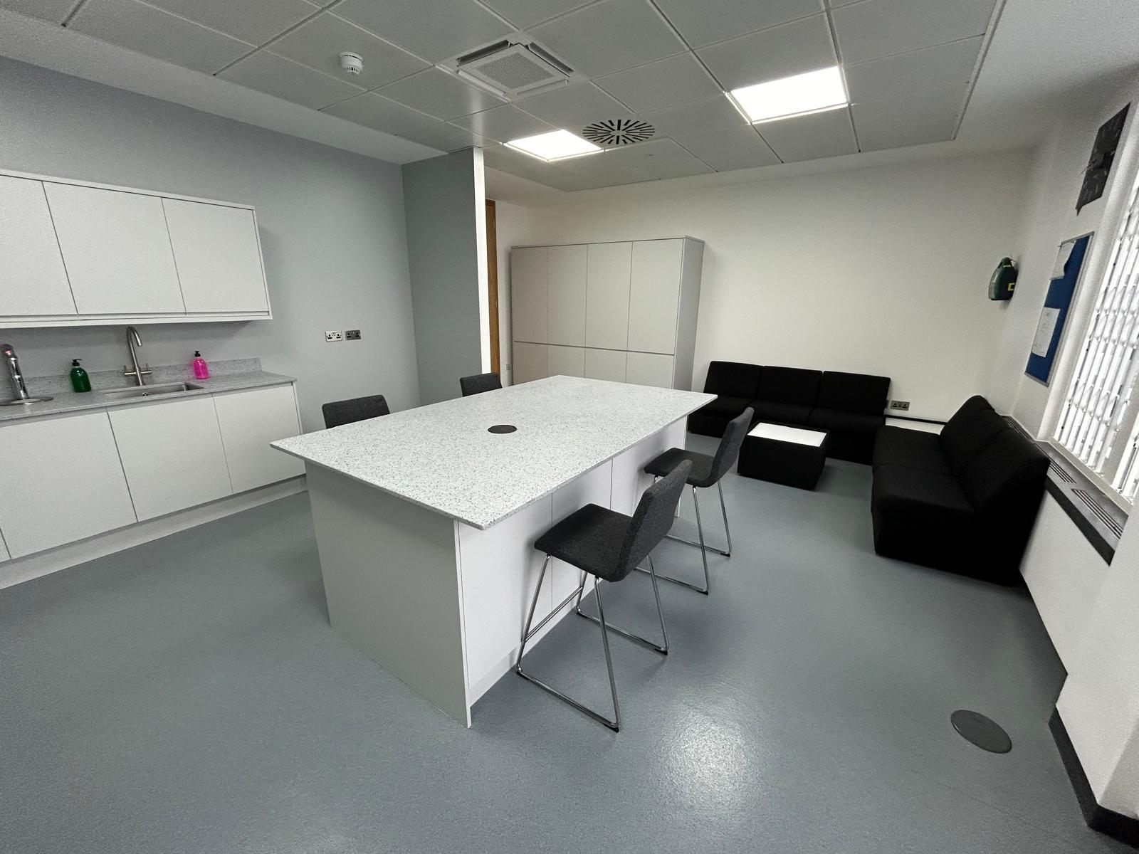 Refurbished kitchen and breakout area with island seating and soft seating