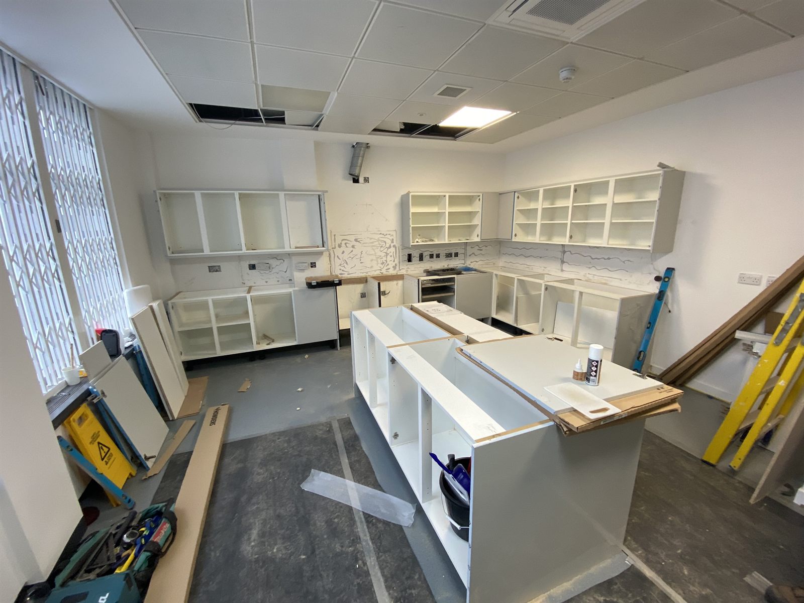 Kitchen mid-refurbishment with new carcasses and island being installed