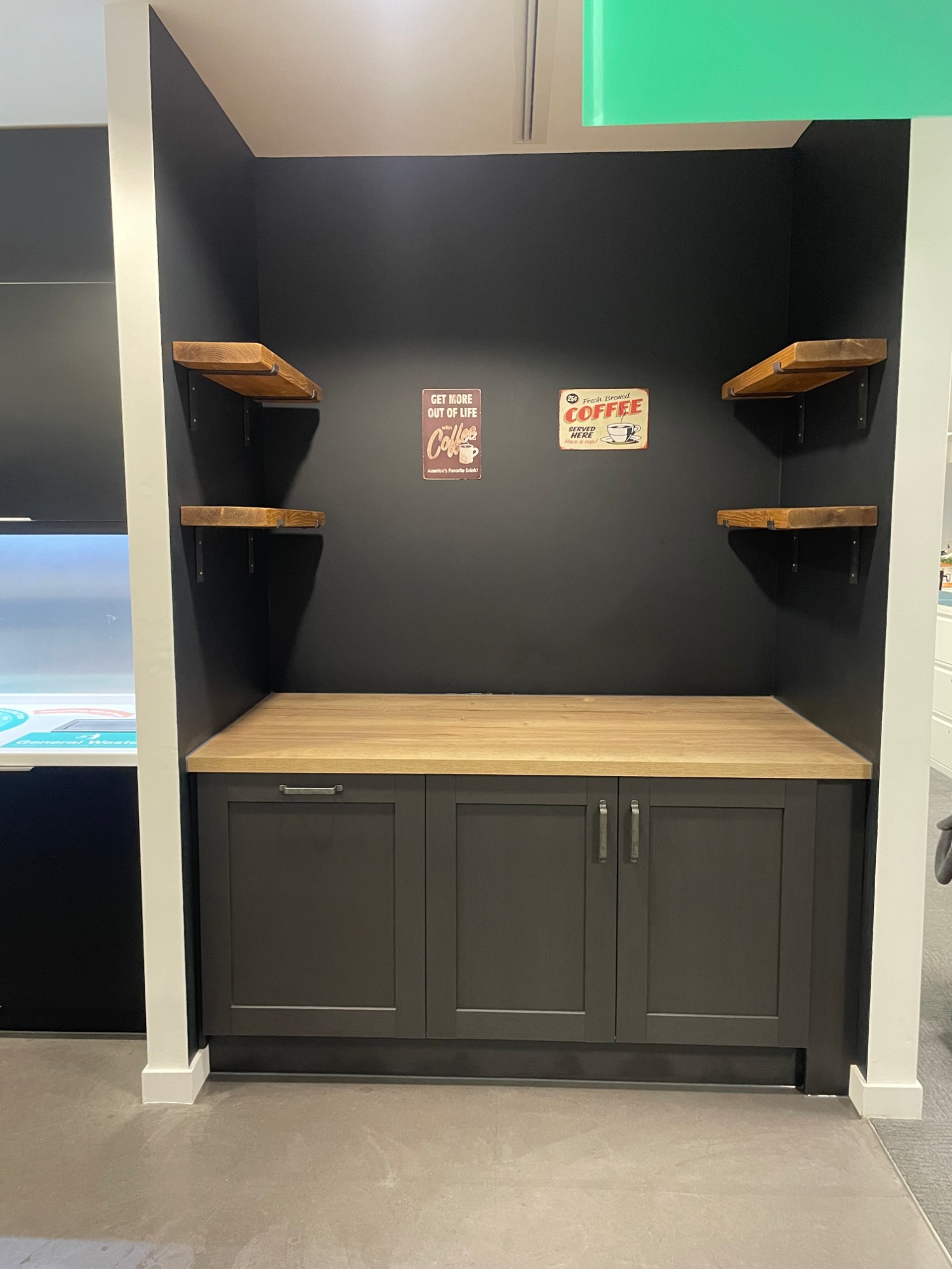 Coffee bar with oak worktop, dark cabinetry and floating timber shelves