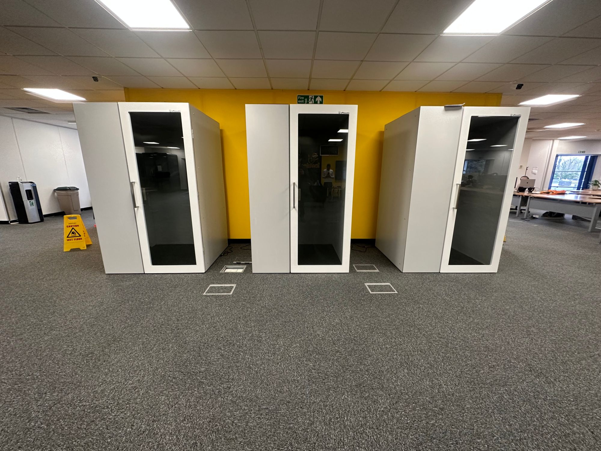 Three acoustic office pods installed in an open plan office